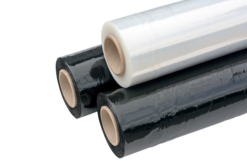 Three rolls of stretch film packaging black and transparent. Wrapping film. Isolated on white background.